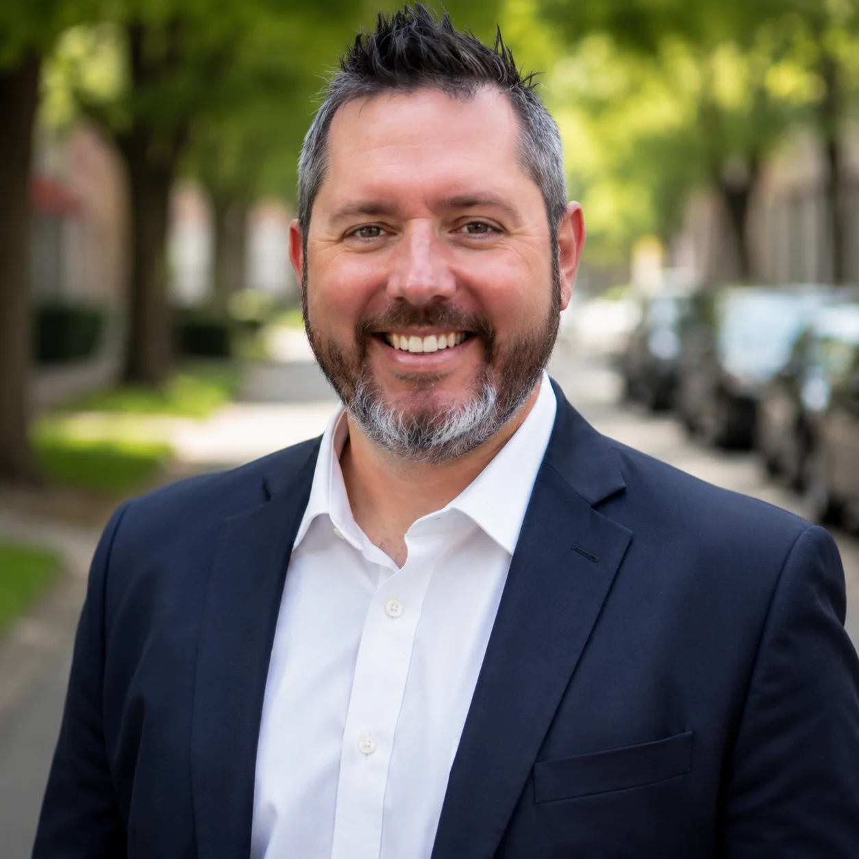 Portrait of Jeff Garrett, founder of GVP, smiling in a tree-lined street.